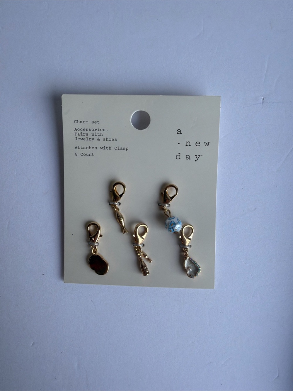 a new day Gold Charm Set with Light Blue Bead (5 Pieces)